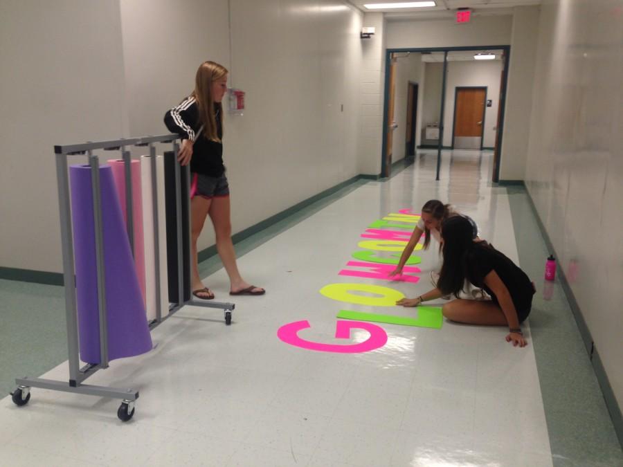 Students in Leadership work to create posters and props for homecoming week.