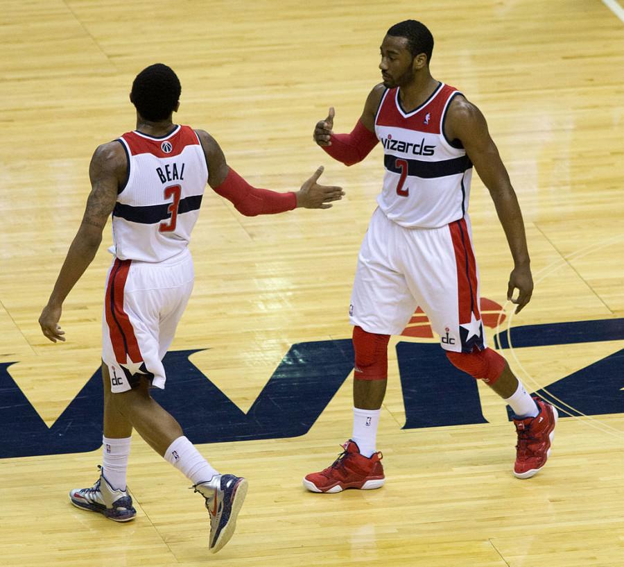 Wizards guards  John Wall and Bradley Beal exchange a high five during a game.