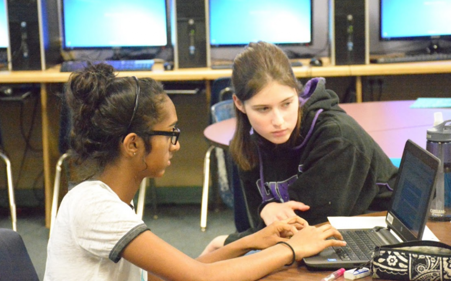 Senior and peer tutor Sarah Hargett helps freshman Nandini Ramkumar with a project.