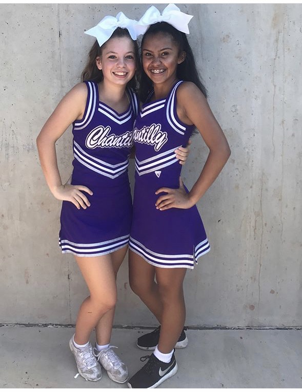 After tryout week, freshman Diana Reyes-Rivera, right, takes a picture with her friend, freshman Kamdyn Corbin, in their uniforms. As a member of the JV cheer team, Reyes-Rivera is required to cheer at JV football games and daily cheer practice.