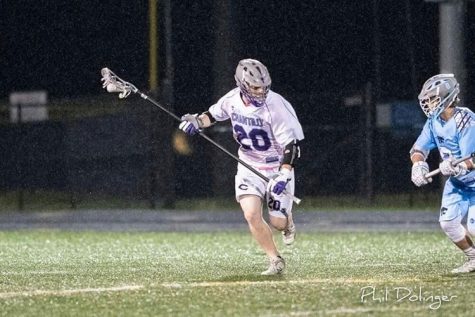 Senior and lacrosse defender Ryan Morris runs upfield with the ball during a game. Morris, who committed to Virginia Wesleyan University last year, found the recruiting process to be very rewarding.