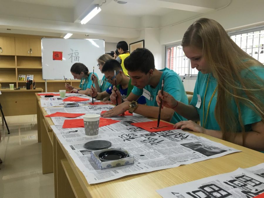 Junior Celie Feighery practices writing Chinese characters during her recent trip to China.