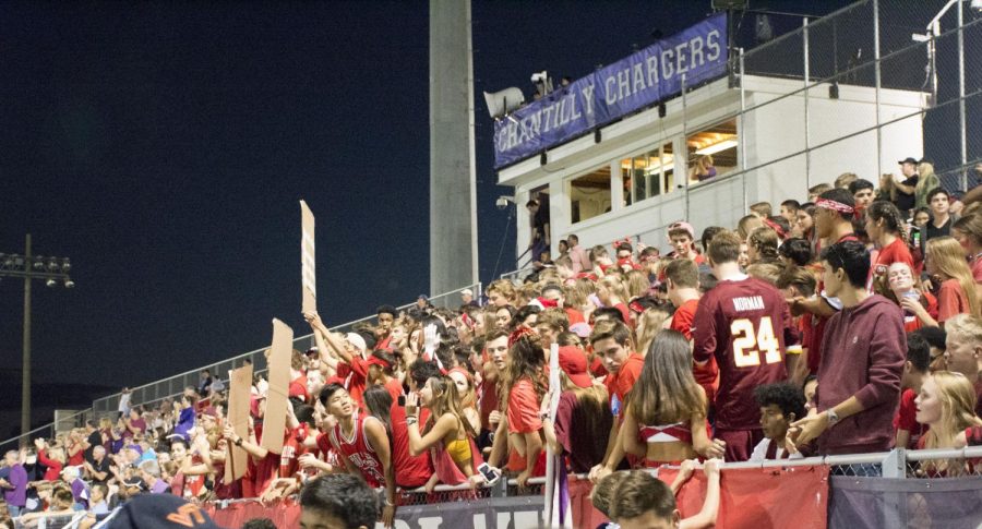 Students cheer for the Chargers on the refurbished bleachers during the varsity football game.