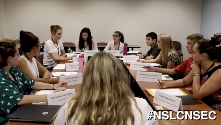 Sophomore Eva William, third from left, participates in a National Security Council simulation as part of the National Student Leadership Conference at American University over the summer.