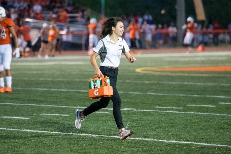 Senior Camille Ohanian, an assistant athletic trainer, helps with managerial duties of the sports managers, handing out water and helping out the team. 