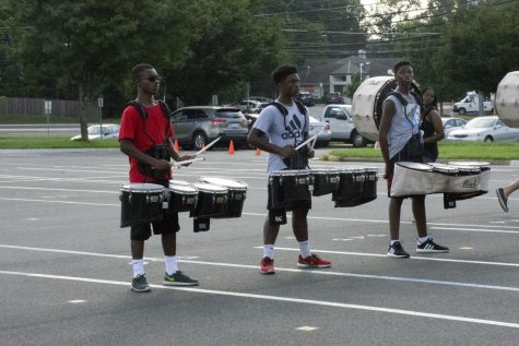 Tenor drum players and juniors Jonah Northern and Ricky McGlothin and sophomore Lans Fofana play in sync during practice.