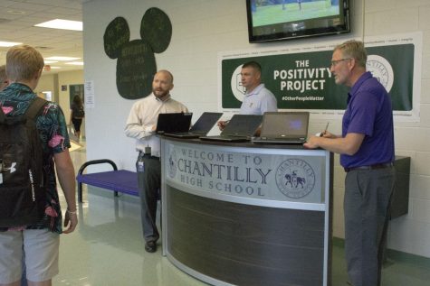 Subschool 2 Assistant Principal Zack Winfrey, Director of Student Activities Corey Bowerman and Principal Scott Poole admit late students using the tardy table set up at the front entrance.