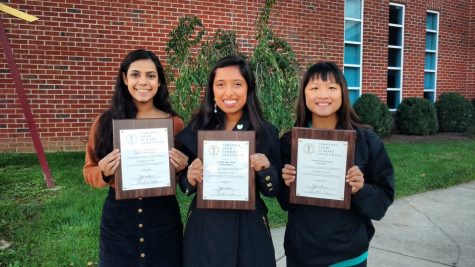 Seniors Priya Viswanathan and Kat Sharma and junior Julia Cheng pose with their programs' awards at the event.