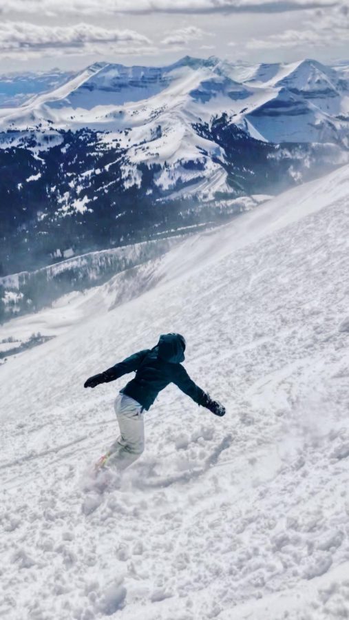 Junior Colette Trinh enjoys the view while snowboarding down Lone Mountain in Montana.