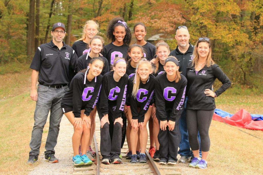 The varsity girls cross country team poses for a photo before the district meet. The team went on to win the district title for the first time since 1999 before winning third in the region.