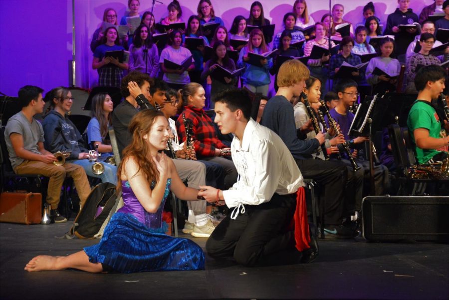 Senior Haley Herman (left) as Ariel and senior Jun Ito (right) as Prince Eric act out scenes from Disneys The Little Mermaid as the band plays the melodies during their dress rehearsal. 