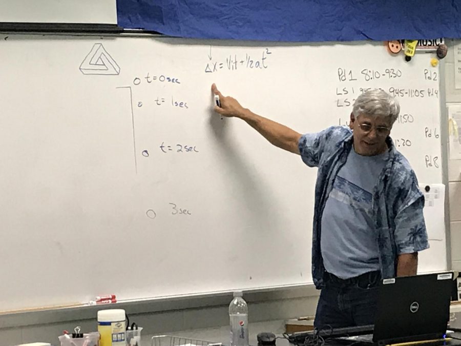 Science teacher Patrick Matalavage demonstrates a physics problem on the white board during seventh period on October 1. 