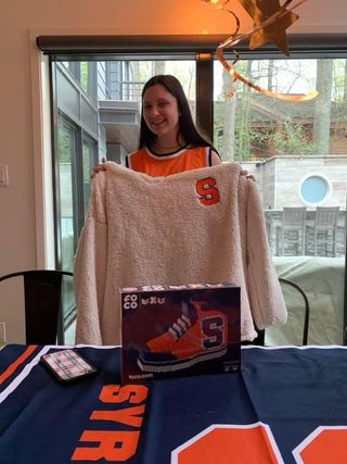 Junior Katherine Richer poses for a picture with Syracuse University gear ahead of this year’s tournament.
