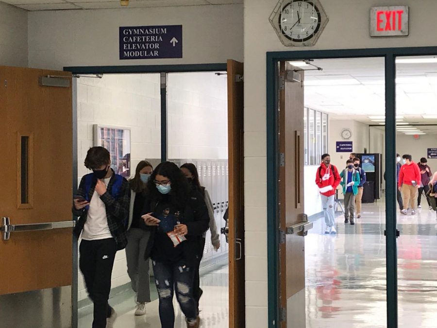 On March 2, freshman and seniors who chose to return to in-person learning walk to their next class on the first day in the building.