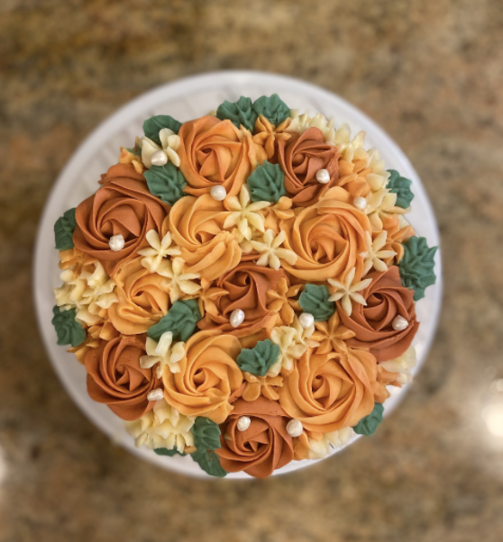 The photograph above pictures one of Namya Kohli’s orders, a fall themed vanilla cake with hand piped floral decorations.