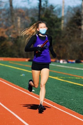 Junior Ava Miller runs in a district meet against Westfield and Madison in the previous winter track season. 