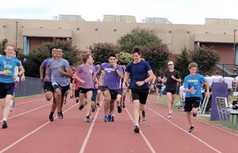 Sophomore Alex Morris, senior Orion Hairston, sophomore Rudra Dave, junior Raymond Creeks, sophomore Sebastian Nowicki, junior Brian Creeks and sophomore Colt Craddock warm up for their practice by doing strides on the track on Monday, Sep. 20.
