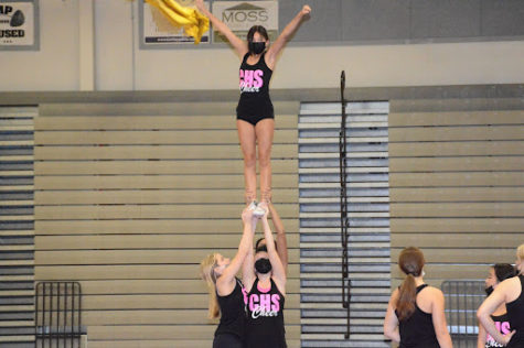 On Sept. 16, junior Amber Villanueva practices her routine with her stunt group of freshman Brianna Wade, junior Lauran Carr and junior Sammie Senio during cheer practice.