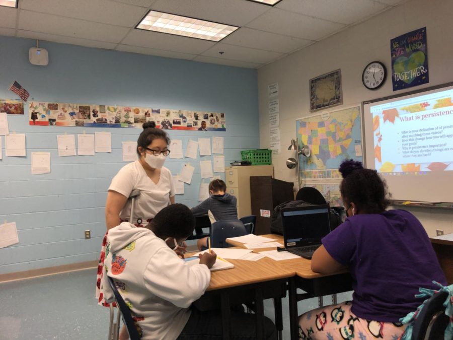 Special education social studies teacher Angela Moon helps sophomore Jaylen Cumberbatch and freshman Lily Myers with classwork during her sixth period class on Sept. 23. 