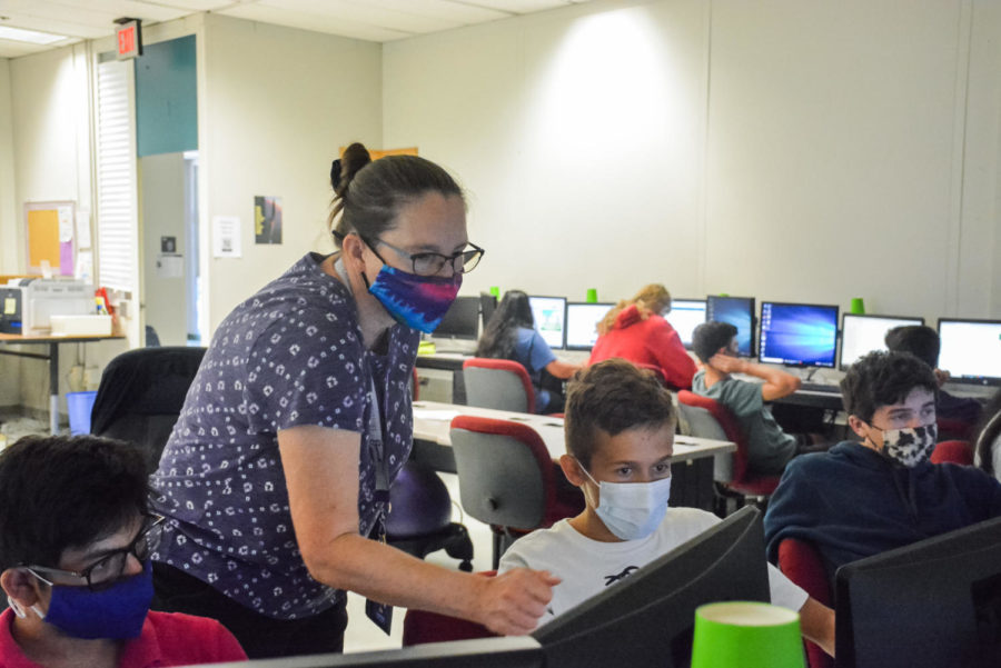 Programming teacher Cynthia Belsky helps her students Krishiv Parekh, George Filippov and Cody Kidd with a code in her programming class on Sept. 20.
