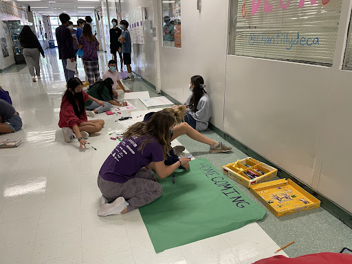 Leadership students decorate posters for the homecoming dance and football game. Homecoming is one long-standing high school tradition that emphasizes boys sports, as similar traditions are not present in girls sports.
