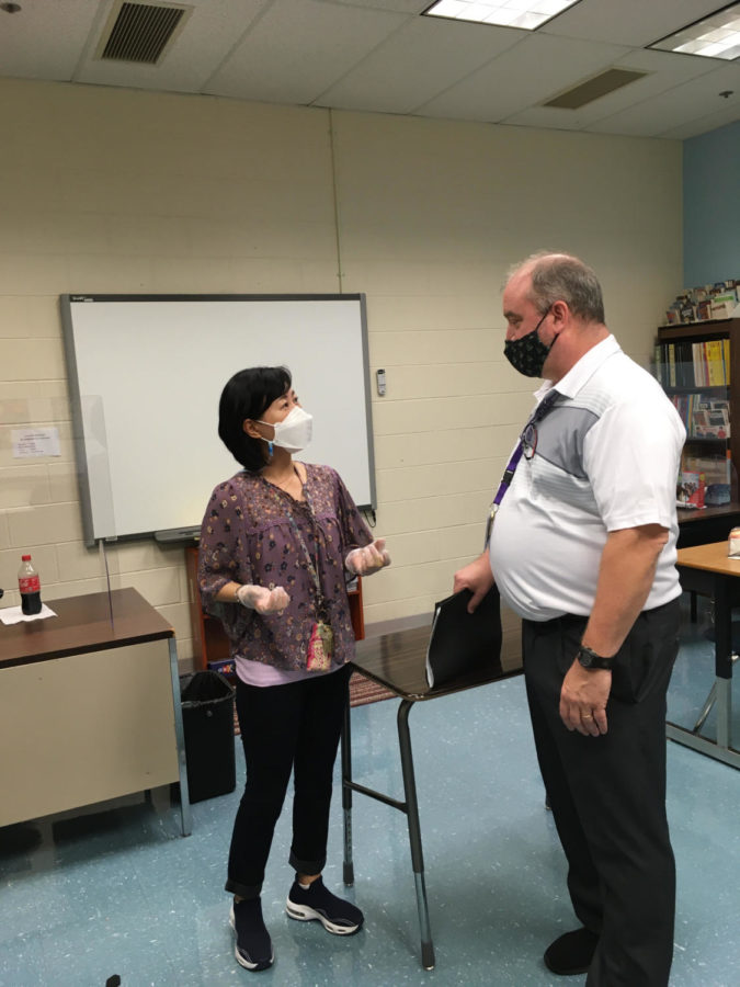 Special education math teacher William Ruffle collaborates with special education teacher SuJin Han.
