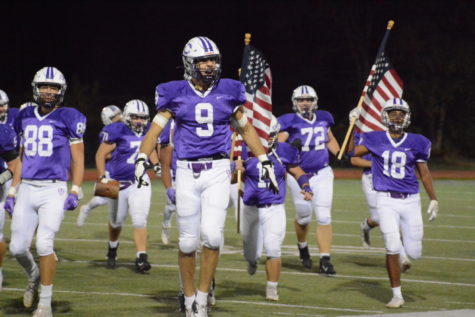 Aiden Gobaira (#9) leads the team out onto the field before their game against Oakton High School on Oct. 22. Chantilly defeated Oakton 21-7. 