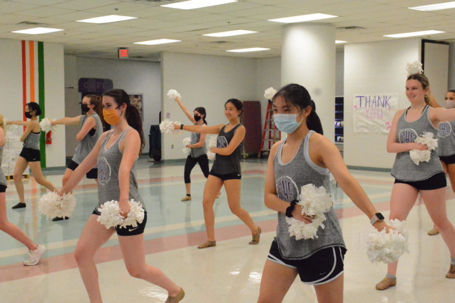 Senior Sydney Schneider, junior Julia Shen, senior Kaitlyn Chou and junior Claire Myers practice alongside the rest of the dance team in the cafeteria on Wednesday, Sept. 20. The team performs “Chantilly Lace” at school football games as per long-standing tradition.
