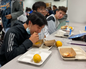 Freshmen Jason Li, Peter Tran and Jayden Cavero enjoy a no-cost lunch, which includes milk, fruit, carbohydrates and meat, in the cafeteria.

