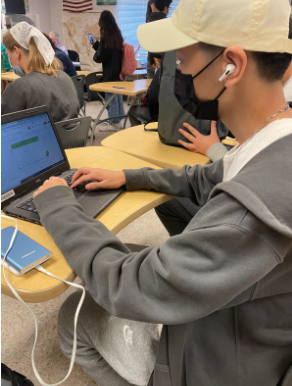 Senior Samuel Park works on an assignment wearing a newly allowed hat on Oct 20. 