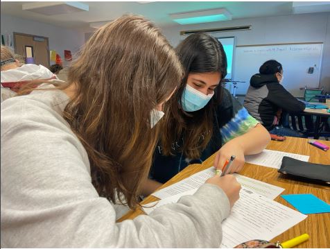 Lending a helping hand, junior Shermeen Yousaf offers advice on an English warm up to junior Mary Sherman on Nov. 9. 
