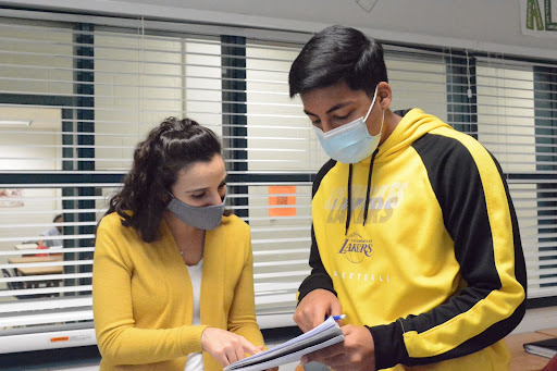 Math teacher Nicole Marinucci helps out senior Siddharth Tibrewala. Open communication between teenagers and adults at school fosters a more positive school environment, beneficial for all.
