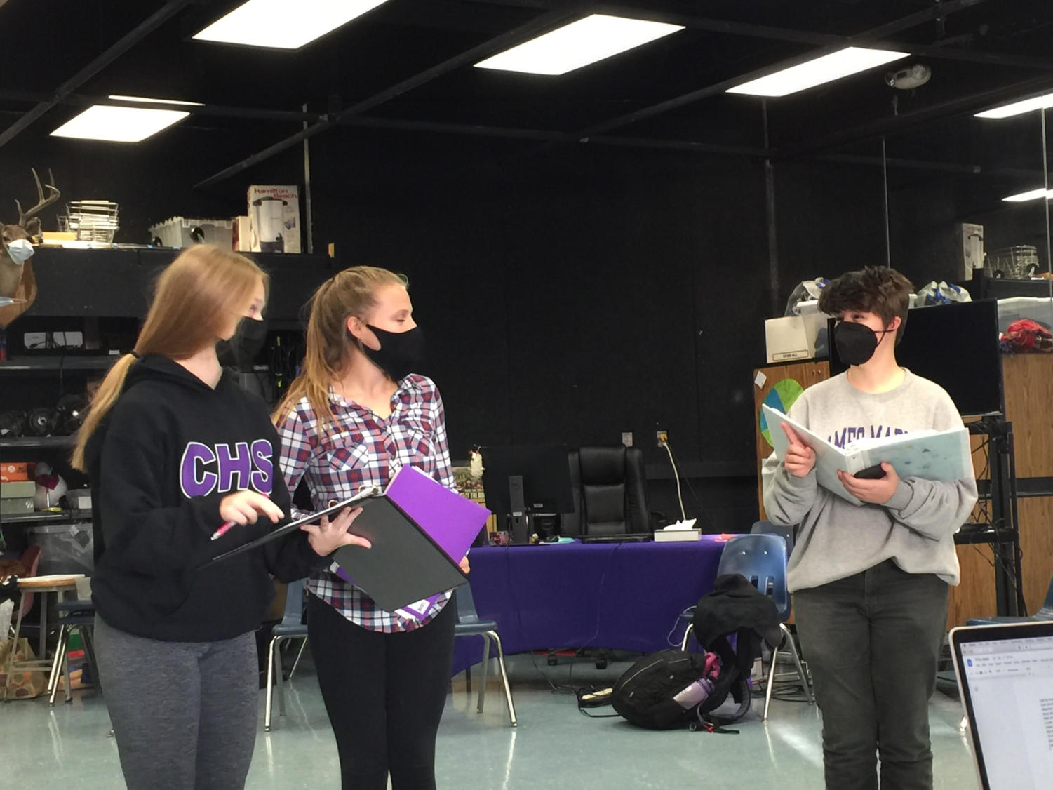 Maddy Latham, Katie Craddock and Loki Anderson run through the script for “Magic In The Attic” during after-school rehearsal on Nov. 16.
