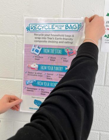 The Students for Environmental Awareness club hangs posters on ways students can contribute to Trex, an environmentally friendly company that manufactures outdoor items from recycled materials