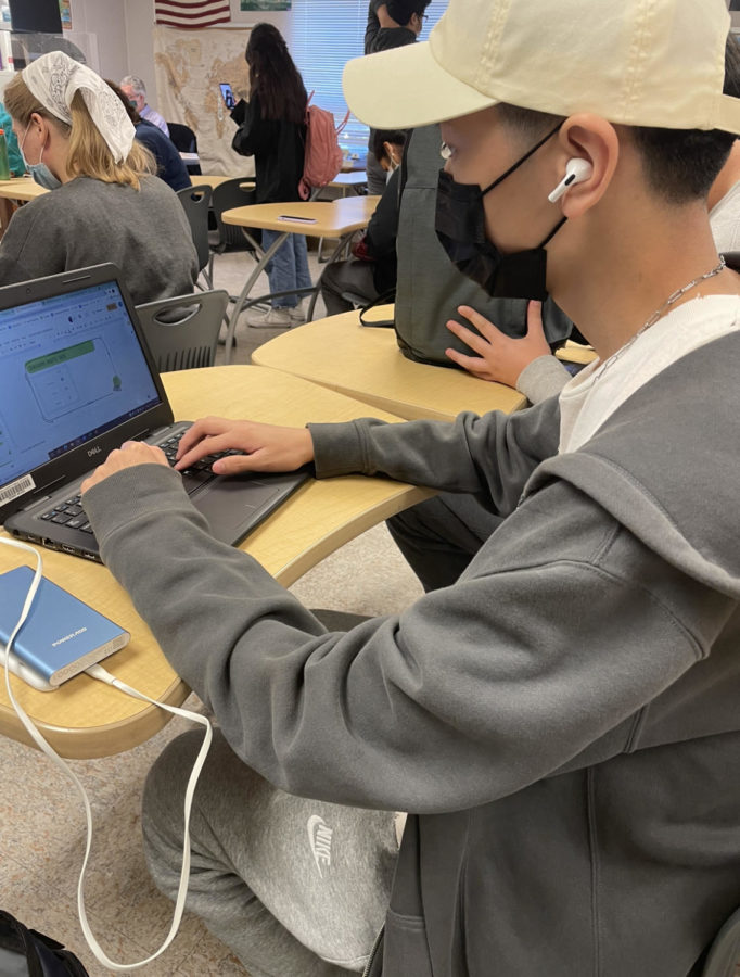 Senior Samuel Park works on an assignment wearing a newly allowed hat on Oct 20.