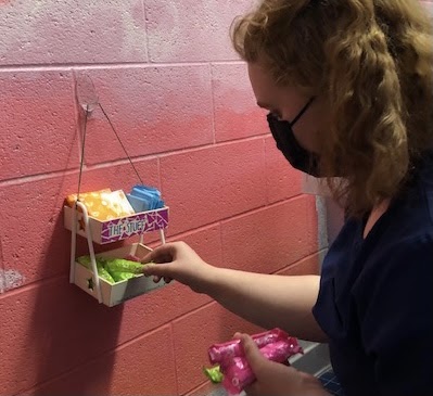 On Nov. 11, senior Becca Marsh refills feminine hygiene products every two weeks in the theater department restrooms. Each refill costs Marsh approximately $10. 