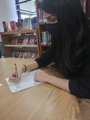 Senior Aneesha Fernandez writes a poem in the school library during CT on March 1. Though poetry may seem daunting at first, new writers can improve by regularly engaging with poetry through reading and writing in their day-to-day lives, according to iUniverse. “Just put your pen to paper. Write something. It doesn’t have to be the greatest poem in the world. No one expects you to be Emily Dickinson or Maya Angelou,” sophomore Kheya Siripurapu said. “It’s your poem. Just keep writing and you’ll get better.”