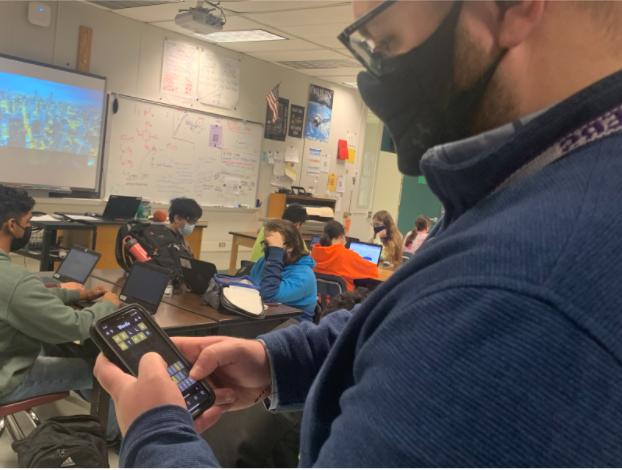Physics teacher Tanner DeCrapio plays Wordle as his students work in class.