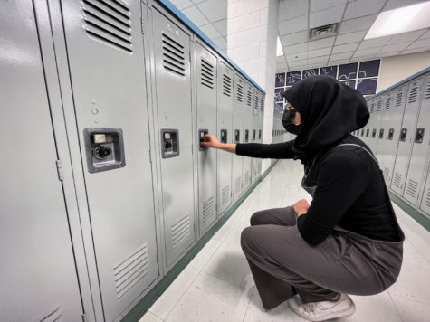 Junior Somaya Elaoud opens her locker to grab her lunchbox. 