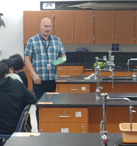 Biology teacher Brandon Orr explains how chalk, a form of rock, affects bio life to his fifth period class.