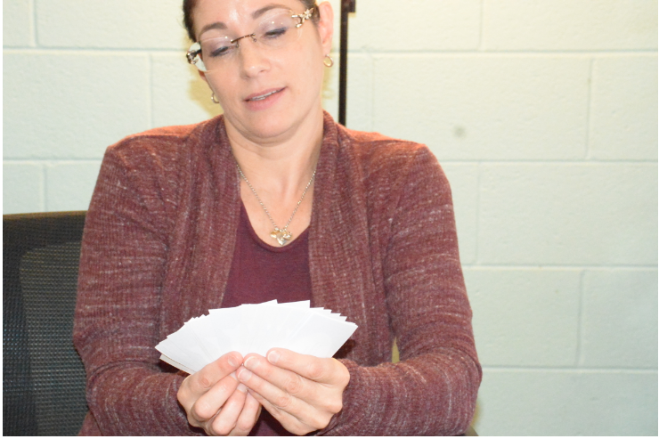 School psychologist Julie Robinson holds up her question cards, an activity she does with students so that they can reflect on their recent highlights as well as what they look forward to.  