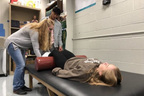 Physical and occupational therapy teacher Lindsay Grilliot teaches senior Andrew Jung to apply an ice pack to Westfield senior Skylar Cowell in her 1st period Physical and occupational therapy 1 class. 