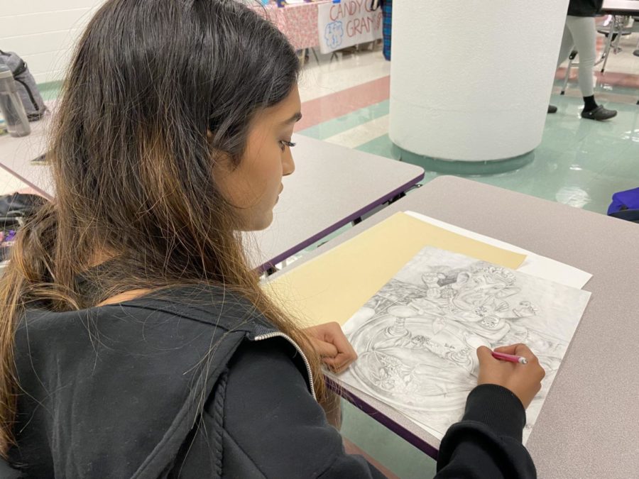 Junior Tanisha Lanka adds the final touches to one of her pieces illustrating her cultural identity
