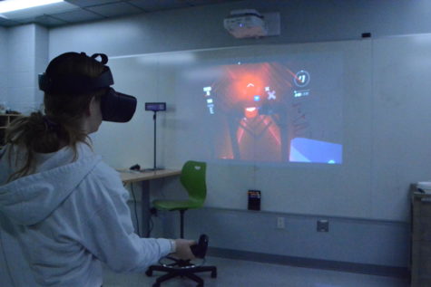Senior Emily Scott plays Beat Saber with VR in the Innovation Lab.