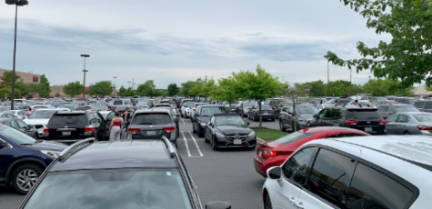 A vast parking lot in Chantilly bustles with cars, illustrating the extent to which cars have dominated transportation in our communities.
