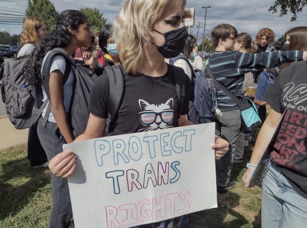 Junior Austen Locke holds a sign that says Protect Trans Rights.