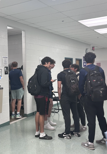 Students chat while waiting in the long line to use the bathroom between passing periods.