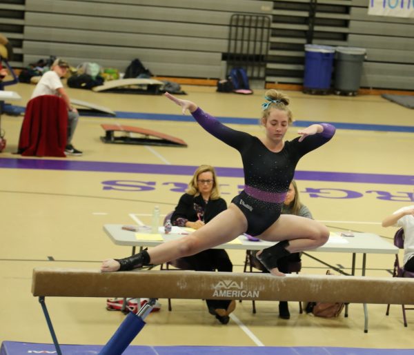 Senior Hannah Liddiard performs a wolf turn on the beam. Liddiard ended with a score of 7.8 on beam. “Gymnastics is important to me because it has made me confident and showed me how powerful I am when competing and learning new skills,” Liddiard said. 