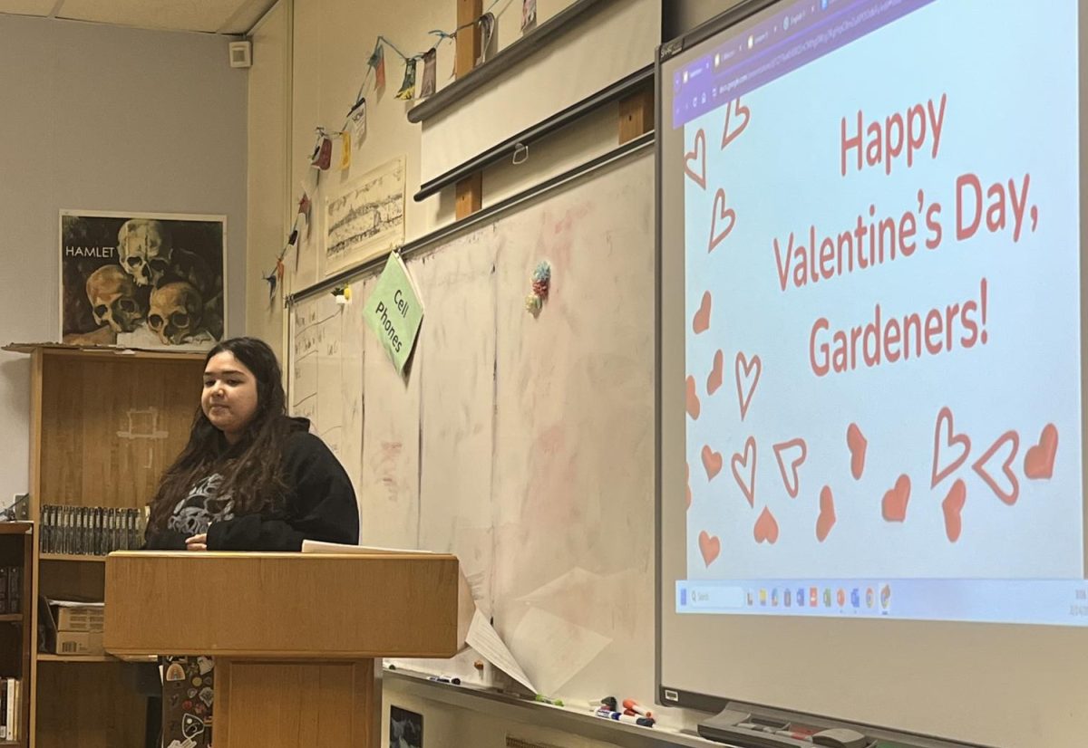 Club president senior Chloe McGeehan presents the slides for the Valentine’s Day themed meeting on Feb. 14. 