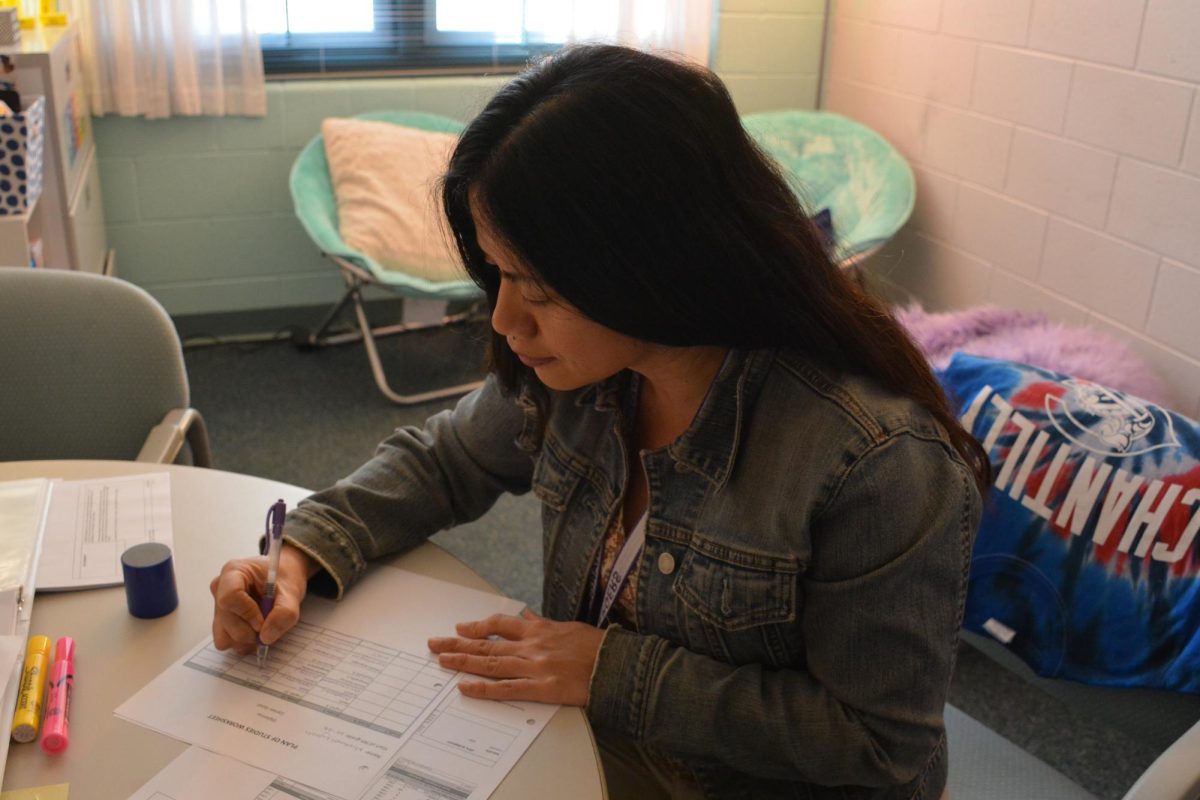 Hard at work: Student counselor Roselyn Abrigo plans out schedules in her office on Sept 5. 
